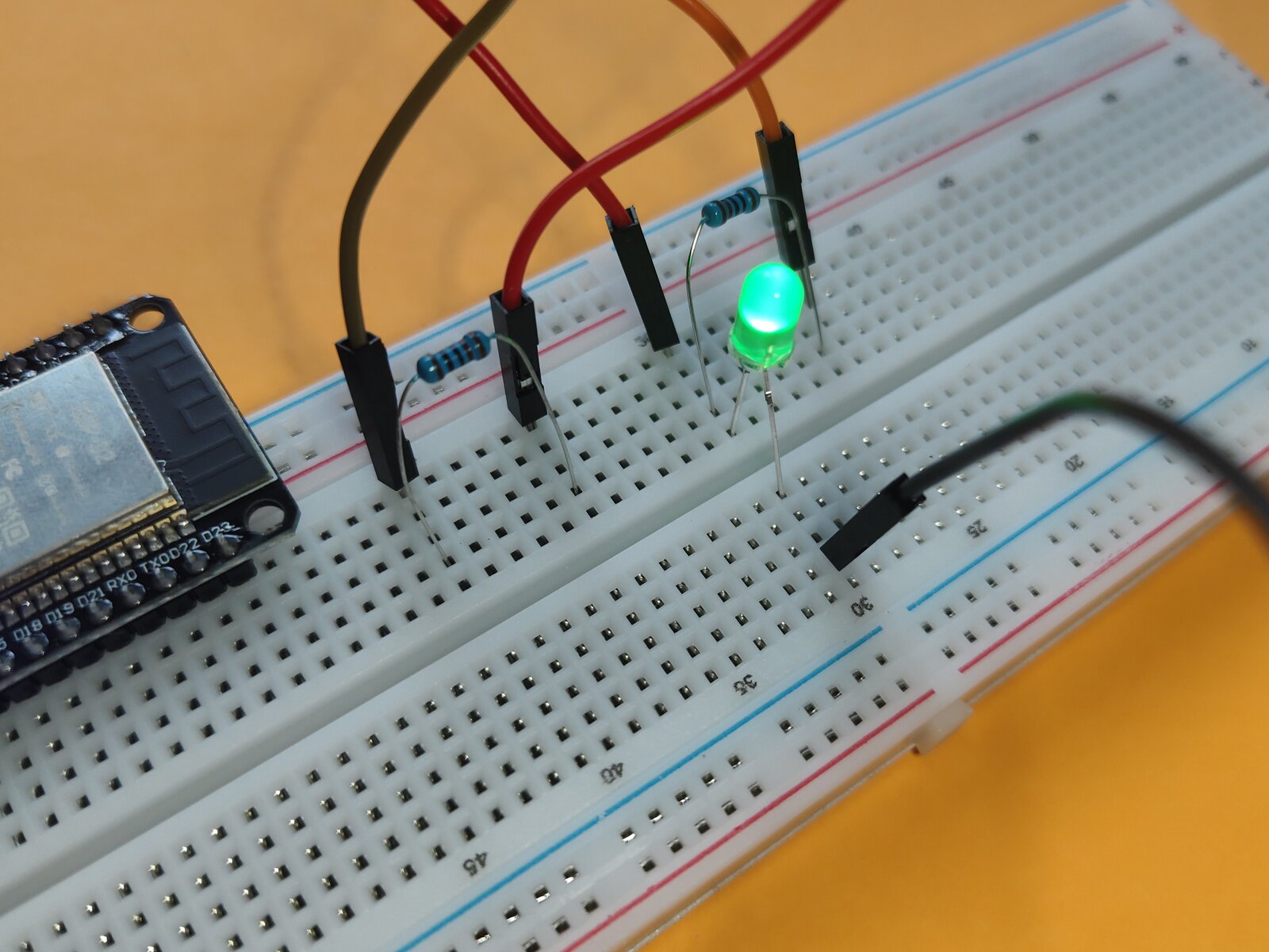 Voltage divider circuit with green LED on breadboard